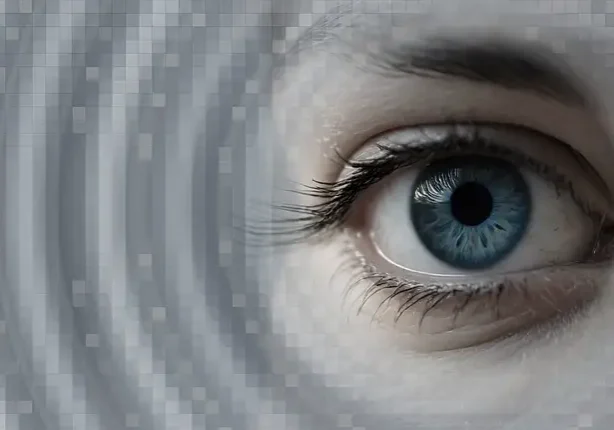 Close up of blue eye staring outwards next to background rings/ripples